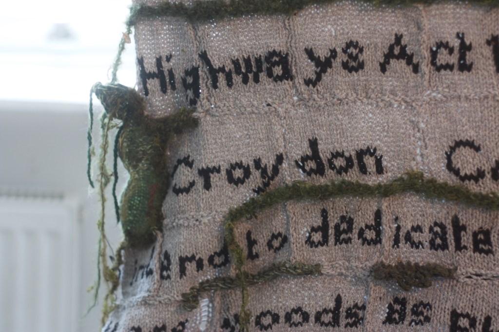 detail of knitted Croydon council sign: 'Highways Act ... Croydon C ... tend to dedicate ... woods as.'